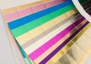 Metallic Foil Printing Brisbane - Fanned out sheets of Foil colours for printing with Infinite Print Brisbane