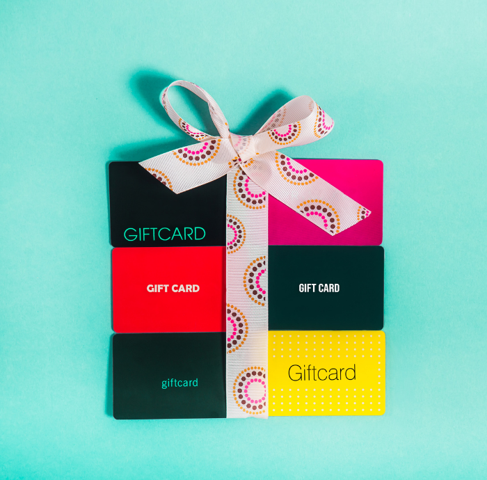 best plastic card printer in Brisbane - image of colourful gift cards with patterned ribbon tied in a bow - call Infinite Print today
