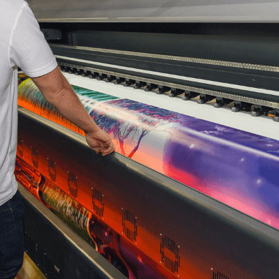 Man standing near large colourful image being printed - Brisbane Large Format Printing - Call Infinite Print